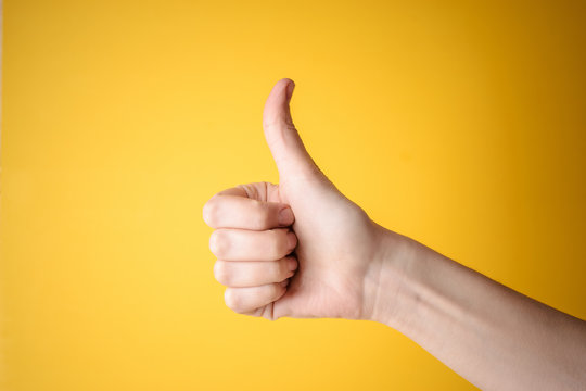 Emale Hand Showing Thumbs Up Gesture