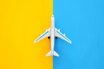 top view photo of toy airplanover double colorful background. Concept of imagination, creativity, dreaming and childhood.