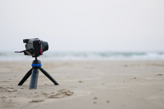 Small camera on stand Take a photo of the sea in the summer vacation concept