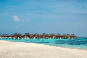 Fototapeta na wymiar Over water bungalows on a tropical island, Maldives