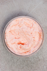 Homemade salmon pate in the glass jar on gray textured table