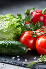 Delicious composition of assorted fresh vegetables and herbs on white textured background, top view, selective focus.