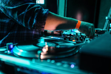 Obraz premium Close up of dj control panel playing party music on modern player in disco club