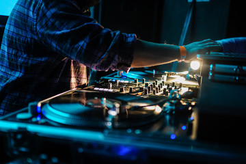 Obraz premium Close up of dj control panel playing party music on modern player in disco club