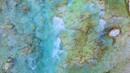 AERIAL top down view: flight over mountain river Soca. Camera flying forwards