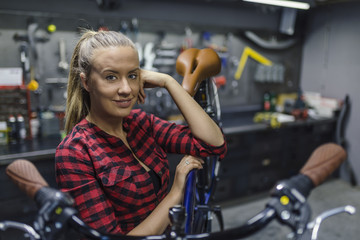 The best bicycle repair woman in town. Young woman working in a biking repair shop