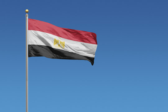 Flag of Egypt in front of a clear blue sky