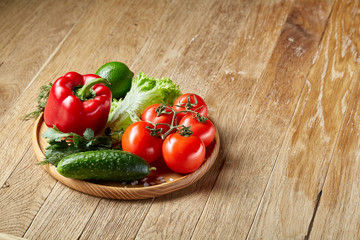 Artistic still life of assorted fresh vegetables and herbs on rustic wooden background, top view, selective focus.
