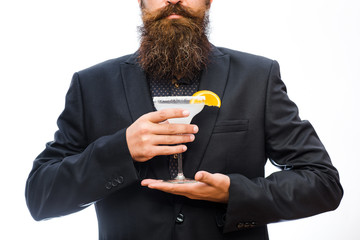 Hipster prepared cocktail. Man holds glass, delicious cocktail with orange,