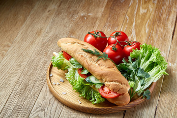 Artistic still life of assorted fresh vegetables and herbs on rustic wooden background, top view, selective focus.