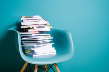 A stack of books in the interior in a minimalist style. Monocolor. The concept of reading,...