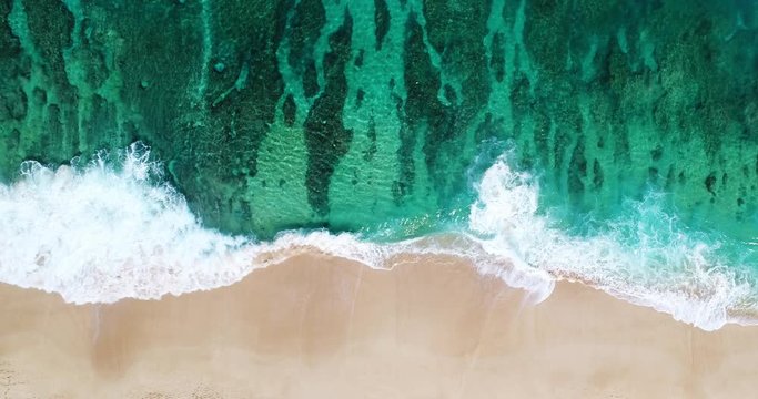 Aerial View Ocean Waves Crashing On Topical Shoreline Of White Sand Beach On Summer Beach Day With Coral Reef 