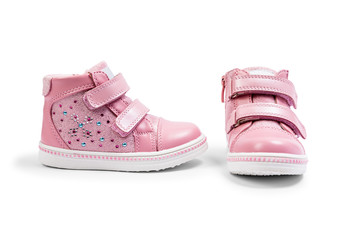 the pink children's sneakers isolated on a white background