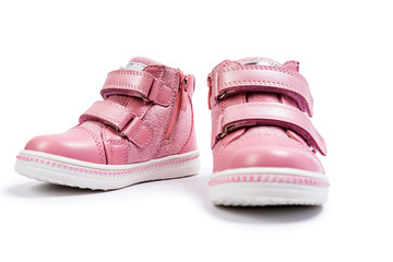 the pink children's sneakers isolated on a white background