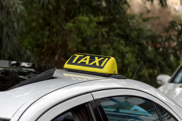 Details of yellow taxi cars on the city street.