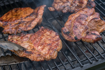 pork steak meat on bbq grill