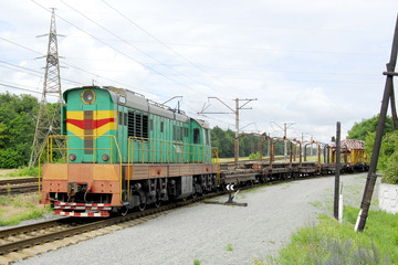 Fototapeta premium The diesel locomotive pulls the train carcasses with rails and sleepers.