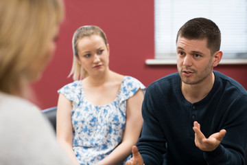 Fototapeta premium Couple Discussing Problems With Relationship Counselor