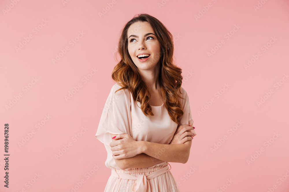 Wall mural Portrait of a laughing young girl in dress standing