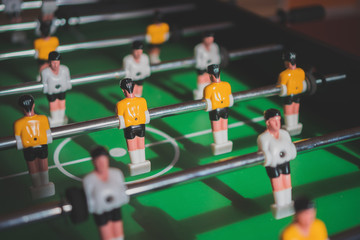 Table football game with yellow and white players.