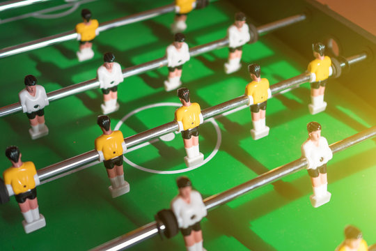 Table football game with yellow and white players.
