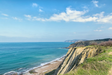 Fototapeta na wymiar wild beach with awesome cliffs along the coast