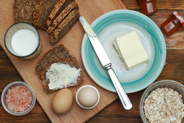 Healthy Breakfast. Fitness food. Eggs, Bread, Butter, Milk. Wooden Background. Flat Lay.
