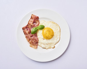 tastu fried egg in plate with bacon