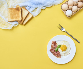 tastu fried egg in plate with bacon
