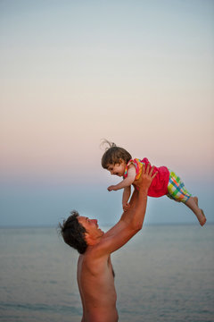 Father and daughter having fun at beach