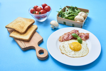 tastu fried egg in plate with bacon