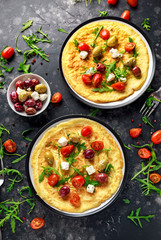 Vegetables Eggs Omelette with tomatoes, wild rocket, greek cheese, olives in a plate. Morning breakfast. healthy food