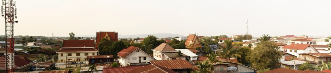 Fototapeta na wymiar panoramic view of a typical southeast asian town, with temples and iron roofs, Laos, Southeast Asia