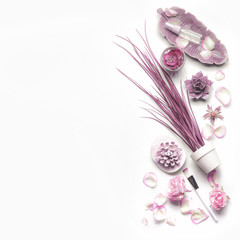 Pink purple cosmetic set for facial skin care with roses on white background, top view, place for...