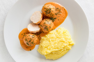 mashed potato and chicken meatballs cooked with rice under sour cream and vegetables sauce