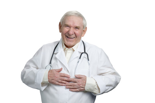 Old doctor laughing heartily touching stomach. Caucasian senior physician having fun in white isolated background.