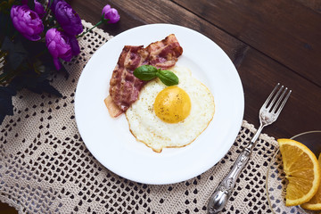 tastu fried egg in plate with bacon