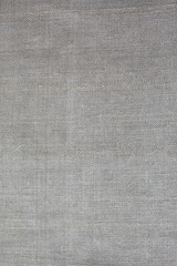 Fototapeta na wymiar Grey rustic textile linen background. Fabrics texture. Ecological modern cloth.