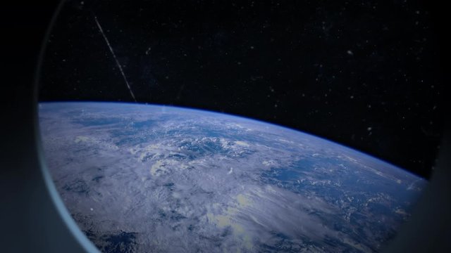 Earth is seen through scratched window of a spaceship. NASA Earth footage has been used