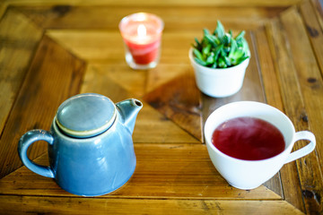 Fototapeta na wymiar Red Fruit Tea on wood table with bokeh 