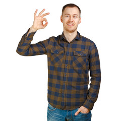 A nice young man wearing green checkered shirt shows Ok symbol. Isolated on white background.