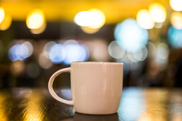 Coffee Lattee on the wooden table with back light
