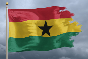 Ghana Flag with torn edges in front of a stormy sky