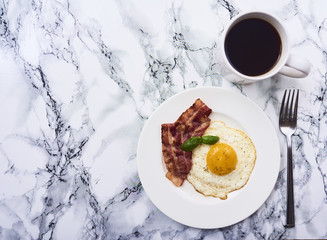 tastu fried egg in plate with bacon