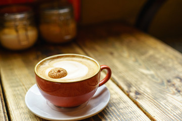 Caffe Latte with wooden background