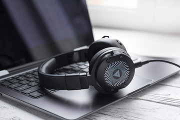 Black headphone and laptop computer