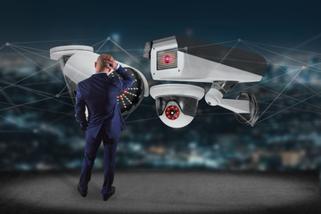 Businessman holding a Security camera system and network connection - 3d rendering