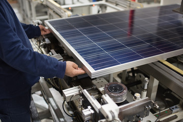 production of solar panels, man working in factory. - 198975042