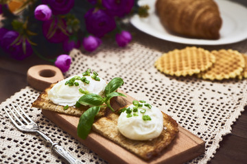 Tasty poached egg on toast over rustic background