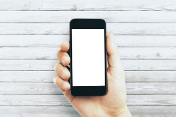 Male hand holding empty white smartphone
